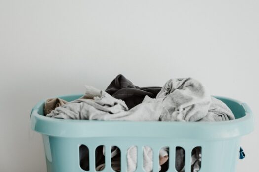 A bright and organized laundry room with natural light, featuring eco-friendly laundry products and neatly arranged textiles.
