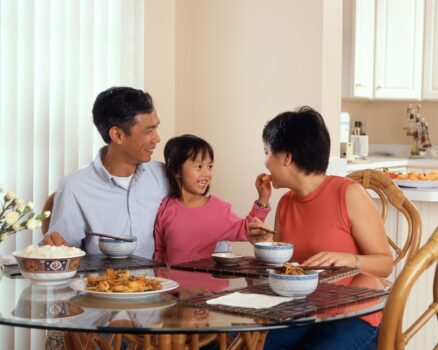 A family enjoying a healthy, natural lifestyle in a cozy home environment, surrounded by plants and eco-friendly products.